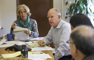 Gov. Jerry Brown discusses a bill while meeting with advisers at his Capitol office on Monday, Sept. 29, 2014 in Sacramento, Calif. Brown has until midnight Sept. 30 to sign or veto hundreds of bills that were approved in the final weeks of the legislative session. At left is advisor Nancy McFadden. RICH PEDRONCELLI — AP
